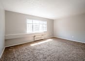 Thumbnail 15 of 25 - A room with a window and a carpeted floor.
