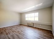 Thumbnail 9 of 25 - A room with a window and a radiator on the wall.