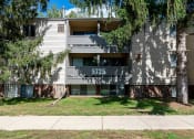 Thumbnail 16 of 18 - an apartment building with a sidewalk and trees in front of it