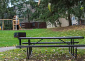 Thumbnail 11 of 18 - a park bench in front of a playground