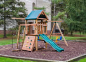 Thumbnail 9 of 18 - a wooden swing set with a slide in a backyard
