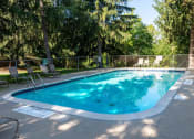 Thumbnail 14 of 18 - a swimming pool with chairs and a fence around it