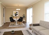 Thumbnail 2 of 16 - a living room with a table and a couch