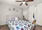 Thumbnail 7 of 18 - a bedroom with a bed and a ceiling fan