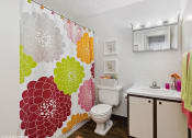 Thumbnail 9 of 12 - a bathroom with a shower tub and a sink and a toilet