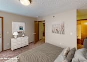 Thumbnail 4 of 6 - A bedroom with a bed, dresser, and two pictures on the wall.