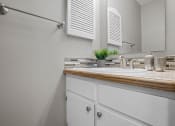 Thumbnail 11 of 29 - a bathroom with a sink and a mirror