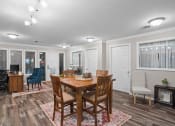 Thumbnail 17 of 29 - a dining room and living room with a table and chairs