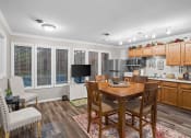Thumbnail 19 of 29 - a kitchen and dining room with a table and chairs