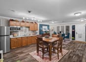 Thumbnail 18 of 29 - a kitchen and dining room with a table and chairs