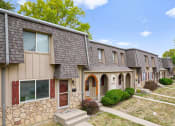 Thumbnail 27 of 29 - a group of houses in a row with a sidewalk and grass