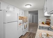 Thumbnail 3 of 29 - a kitchen with white appliances and a sink and a refrigerator