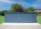 Thumbnail 22 of 32 - a large blue garage door in front of a grassy area