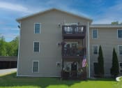 Thumbnail 25 of 32 - the back of a house with a balcony and an american flag