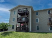 Thumbnail 27 of 32 - an exterior view of an apartment building with a balcony