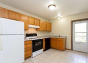 Thumbnail 2 of 32 - a kitchen with a refrigerator freezer and a stove top oven