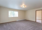 Thumbnail 6 of 32 - a bedroom with white walls and a large window