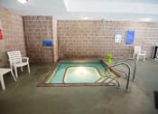 Thumbnail 19 of 32 - a hot tub in a room with chairs and a table