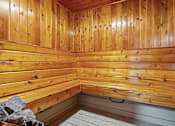 Thumbnail 9 of 21 - A wooden sauna with a bench at apartment complex