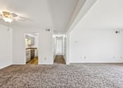 Thumbnail 9 of 34 - A spacious room with a carpeted floor and a ceiling fan.