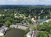 Thumbnail 35 of 35 - A bird's eye view of a residential area with a lake in the foreground.