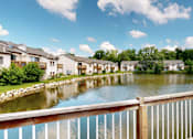 Thumbnail 26 of 35 - A row of houses are situated by a body of water.