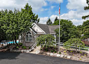 Thumbnail 28 of 35 - A house with a flag on a pole in front of it.