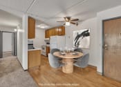 Thumbnail 3 of 26 - a kitchen and dining room with a table and chairs