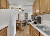 Thumbnail 2 of 26 - a kitchen with a dining table and a refrigerator