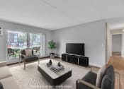 Thumbnail 13 of 26 - a living room with a couch and a television