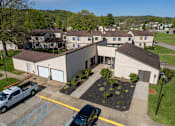 Thumbnail 13 of 20 - A building with a parking lot in front of it.