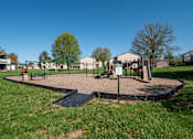 Thumbnail 11 of 20 - A playground with a swing set and a slide.