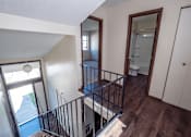 Thumbnail 4 of 20 - A staircase with a metal railing leads to a bathroom.