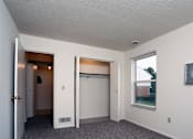 Thumbnail 9 of 15 - A room with a sliding door and a window.