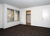 Thumbnail 6 of 15 - A room with a brown carpet and a white door.