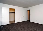 Thumbnail 13 of 15 - A room with white walls and a brown carpet.