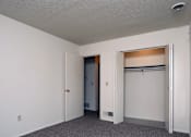 Thumbnail 14 of 15 - A room with a white door and a white wall.