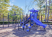 Thumbnail 14 of 18 - A playground with a blue slide and a black structure.