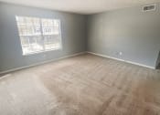 Thumbnail 7 of 18 - an empty bedroom with a large window