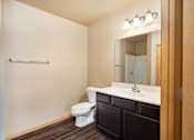 Thumbnail 16 of 29 - A bathroom with a toilet, sink and mirror.