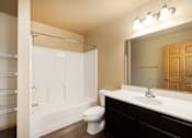 Thumbnail 17 of 29 - A bathroom with a toilet, sink, and shower.