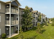 Thumbnail 24 of 29 - Apartment buildings with balconies and trees in front.