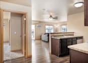 Thumbnail 4 of 29 - A kitchen with a brown counter top and a ceiling fan.