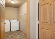 Thumbnail 11 of 29 - A laundry room with a washer and dryer.