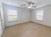 Thumbnail 5 of 17 - an empty room with a ceiling fan and two windows