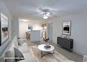 Thumbnail 13 of 20 - A living room with a grey couch, a white coffee table, and a ceiling fan.
