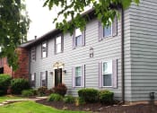 Thumbnail 35 of 35 - a gray house with a red brick chimney