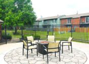 Thumbnail 24 of 35 - a firepit area with chairs at apartment complex
