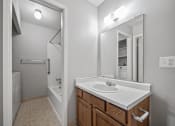 Thumbnail 16 of 23 - an empty bathroom with a sink and a mirror