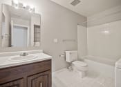 Thumbnail 17 of 23 - a bathroom with a sink toilet and a mirror